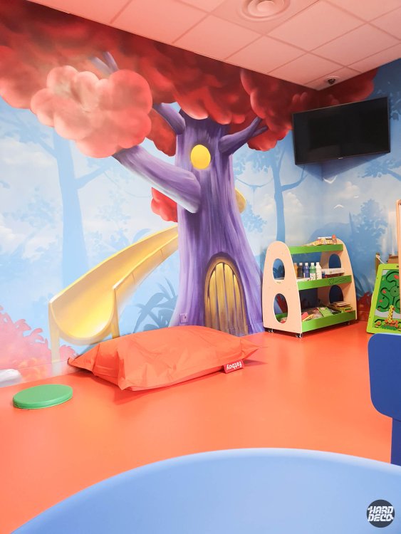 Détail fresque murale arbre violet porte arrondie et nuages rose corail, salle de jeux Fitness Park