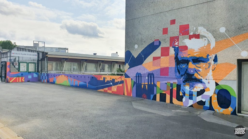 Vue panoramique fresques écoles Victor Hugo Torcy, portrait monumental et fresque géométrique sur cour extérieure