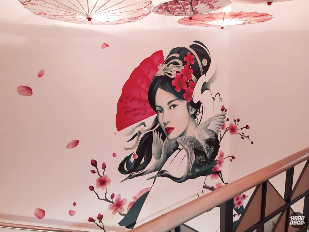 Vue ensemble fresque geisha escalier Kampai Versailles avec ombrelles japonaises au plafond et branches cerisier