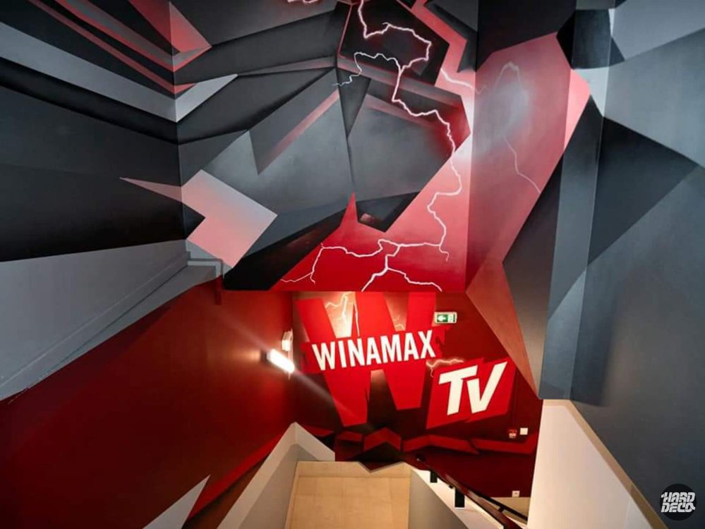 Logo Winamax TV peint sur mur rouge avec éclairs blancs, fresque 3D géométrique gris et rouge