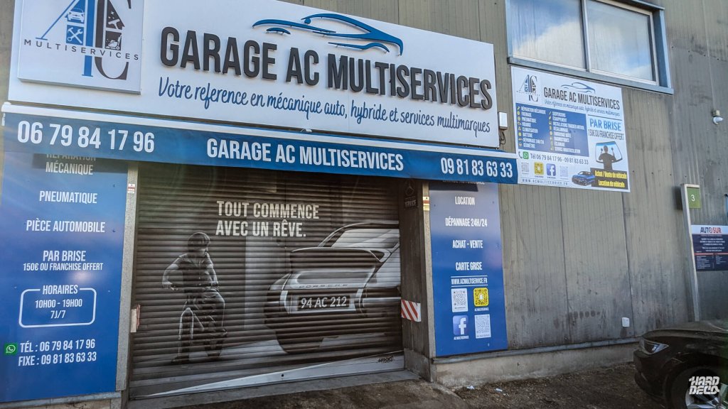 Façade Garage AC Multiservices Alfortville avec fresque aérosol Porsche sur rideau de fer fermé
